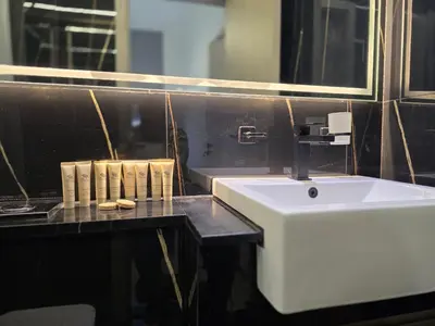 a bathroom with a white sink and a mirror at 1 Bed Retreat- RBE Vacation Homes-Binghatti Luna in Dubai