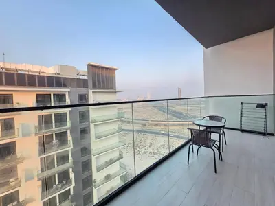 a balcony with a table and chairs on a building at 1 Bed Retreat- RBE Vacation Homes-Binghatti Luna in Dubai