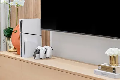a television on a shelf with two figurines on it at FIRST CLASS 2BR Incredible Burj Khalifa View in Dubai