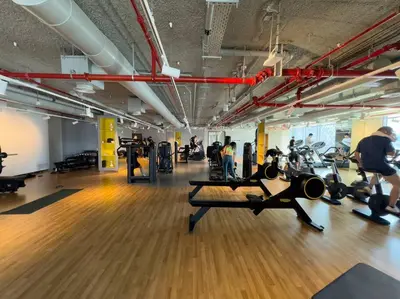 a gym with people exercising on machines in a gym at 2BR near Dubai Mall, Burj views! in Dubai
