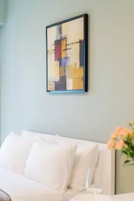 a white couch in a living room with a painting at JLT Studio apartment Goldcrest Executive in Dubai