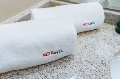 two white towels sitting on a counter top at JLT Studio apartment Goldcrest Executive in Dubai