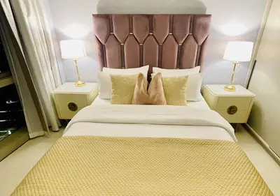 a bedroom with a large bed with two night stands at Direct Burj Khalifa View I Minutes Walk to Dubai Mall I Stunning Fountain Views I One Lux Stay Grande Signature Residence in Dubai