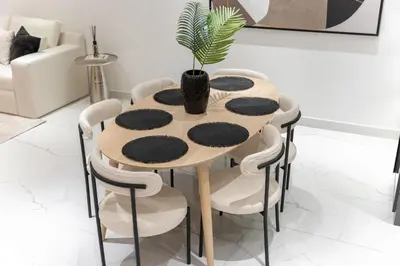 a table and chairs with a potted plant on it at StayShort - Luxurious 2-Bedroom Apartment perfect for families in Dubai Marina in Dubai