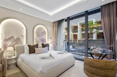 a bedroom with a white bed and a glass table at Luxury Living Studio in the Heart of Business Bay in Dubai