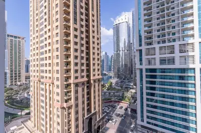 an aerial view of a city with tall buildings at Waves - Cozy Studio with Balcony & Partial Lake Views in Dubai