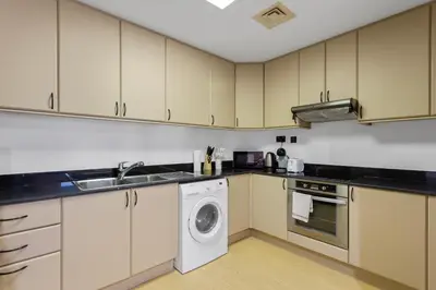 a kitchen with a washing machine and a washer at Dubai Marina FLOOR 89 - AMAZING VIEWS in Dubai