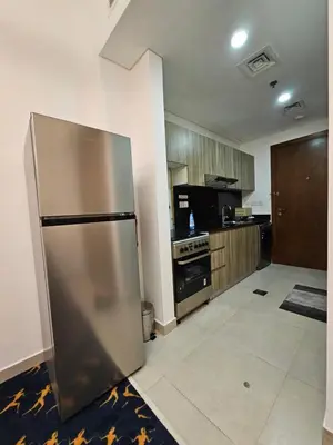 a large kitchen with a stainless steel refrigerator at Room with Kitchen Furnished Apartments by oima leasing property in Dubai