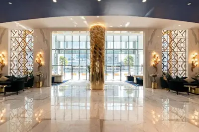 a lobby with a large column in the middle of a building at Spacious Studio with Pool - Canal & Burj Views in Dubai