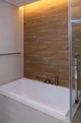 a bathroom with a shower and a bath tub at Mira Holiday Homes - Luxury 1 bedroom with sea view in Dubai