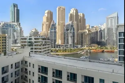 a view of a city with a river and buildings at Royal Marina Experience Lavish 2BR Waterfront View in Dubai