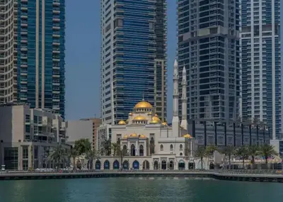 a building in the middle of a city with tall buildings at Royal Marina Experience Lavish 2BR Waterfront View in Dubai