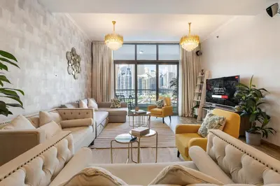 a living room with couches and a tv at Royal Marina Experience Lavish 2BR Waterfront View in Dubai