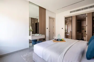 a bedroom with a white bed and a mirror at Frank Porter - Al Samar 1 in Dubai