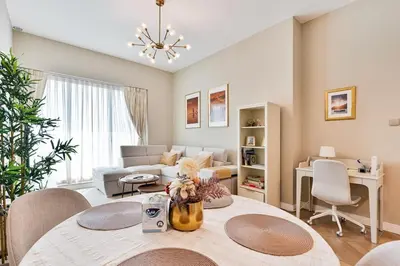 a living room with a table and a couch at Urban Oasis 1BR in Armada with Cityscape Views in Dubai