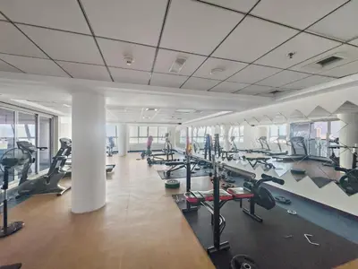 a gym with a lot of treadmills and machines at Urban Oasis 1BR in Armada with Cityscape Views in Dubai