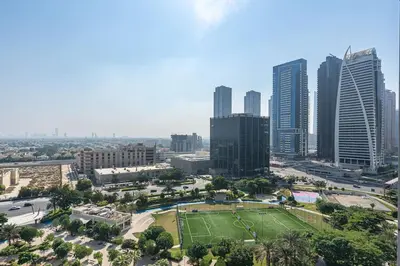 a city with a park in front of a city at Urban Oasis 1BR in Armada with Cityscape Views in Dubai