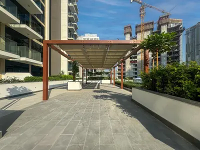 awning over a sidewalk in a city with buildings at Elegant Studio in Azizi Riviera with Luxury Amenities in Dubai