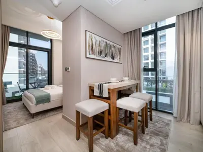 a room with a table and chairs and a bedroom at Elegant Studio in Azizi Riviera with Luxury Amenities in Dubai