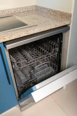 an empty dish rack in a dishwasher in a kitchen at JLT Nice Studio apartment High floor View in Dubai