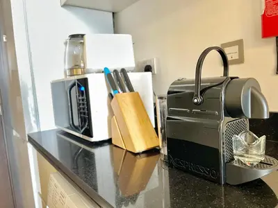 a counter with a coffee maker and a toaster on it at Top Floor Luxurious Apt in JVC, Near Marina in Dubai