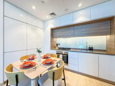 a dining room with a table and chairs in a kitchen at Super Luxury Flat Desing with Sea, Marina and Pool View in Dubai