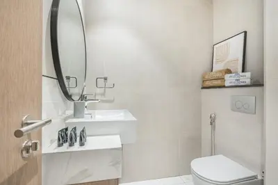 a white bathroom with a sink and a mirror at Bright & Modern Home with Burj Khalifa Views in Dubai