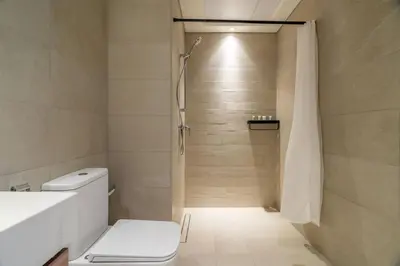 a bathroom with a shower and a toilet at GuestReady - Elegant living in Downtown Dubai in Dubai