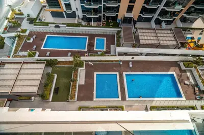 an overhead view of two swimming pools in a building at GuestReady - Elegant living in Downtown Dubai in Dubai
