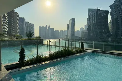 a swimming pool on top of a building with a city at Opulent Lifestyle with Burj Khalifa and Canal View in Dubai