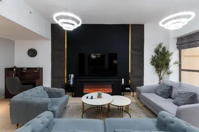 a living room with two couches and a fireplace at Sadaf 5, Jumeirah Beach Residence, JBR - Mint Stay in Dubai