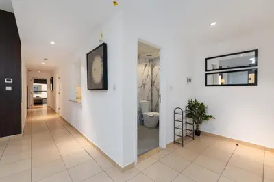 a hallway with a white wall and a mirror at Sadaf 5, Jumeirah Beach Residence, JBR - Mint Stay in Dubai