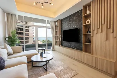 a living room with a couch and a tv at Livbnb-Premium 1B with BurjAlArab Views in Mina in Dubai
