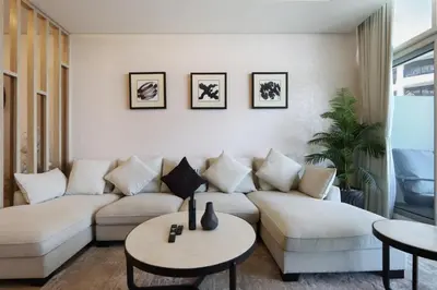 a living room with a couch and two tables at Livbnb-Premium 1B with BurjAlArab Views in Mina in Dubai