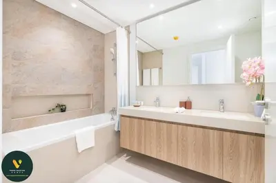 a bathroom with a tub and a sink and a mirror at Vogue Downtown Views II with Direct Access to Dubai Mall Via a Climate Controlled Bridge, Three Bedroom Apartment plus kids room and Balcony with Burj Khalifa View in Dubai