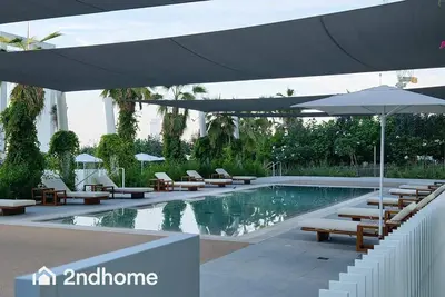 a swimming pool with lounge chairs and an umbrella at La Vie, JBR - Your Perfect Holiday Gateway in Dubai