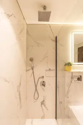 a bathroom with a shower and a sink at Luxurious Apartment next to Burj Khalifa and Dubai Mall in Dubai