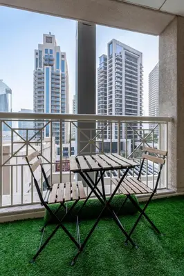 a bench on a balcony with a view of the city at Luxurious Apartment next to Burj Khalifa and Dubai Mall in Dubai