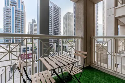 a bench on a balcony with a view of the city at Luxurious Apartment next to Burj Khalifa and Dubai Mall in Dubai