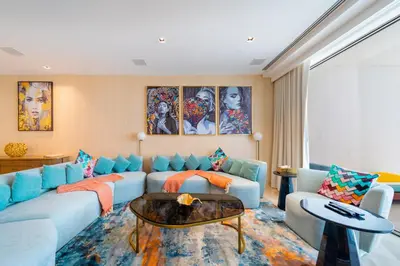 a living room with a couch and a table at Superluxury Apartment in FIVE Palm, Pool & Beach Access in Dubai
