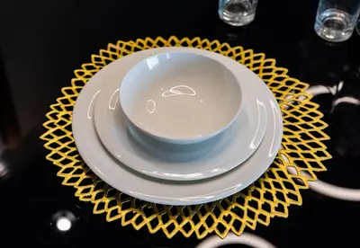 a plate and a bowl on a yellow plate gmaxwell gmaxwell at Superluxury Apartment in FIVE Palm, Pool & Beach Access in Dubai