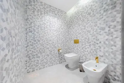 a bathroom with a toilet and a sink at Superluxury Apartment in FIVE Palm, Pool & Beach Access in Dubai