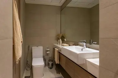 a bathroom with a sink and a toilet and a mirror at Brand New Studio Near Downtown Dubai in Dubai