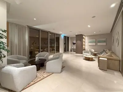 a living room with chairs and a couch and a table at Full Burj Khalifa & Fountain View All Rooms in Dubai