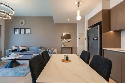 a kitchen and living room with a table and chairs at The View of a Lifetime - Luxury Living with Full Burj Khalifa & Fountain Show in Dubai