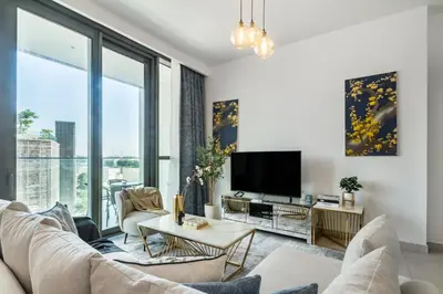 a living room with a couch and a tv at Classy Downtown Bliss with Dubai Mall Access in Dubai