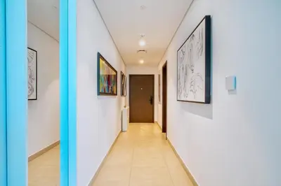 a hallway with paintings on the walls at Classy Downtown Bliss with Dubai Mall Access in Dubai