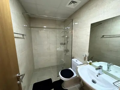 a bathroom with a sink and a toilet and a shower at Sleek 1BR in DSO, Dubai in Dubai
