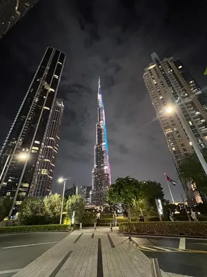 a view of the empire state building at night at Skyline Majesty - Luxury Living with Full Burj Khalifa & Fountain Views in Dubai