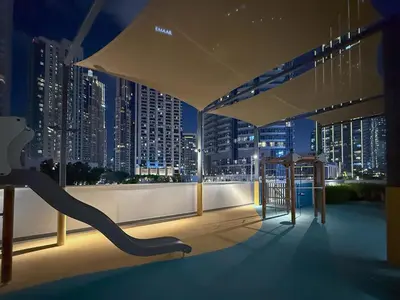 a balcony with a view of a city at night at Iconic Views - Exclusive Burj Khalifa & Fountain Views from Every Angle in Dubai